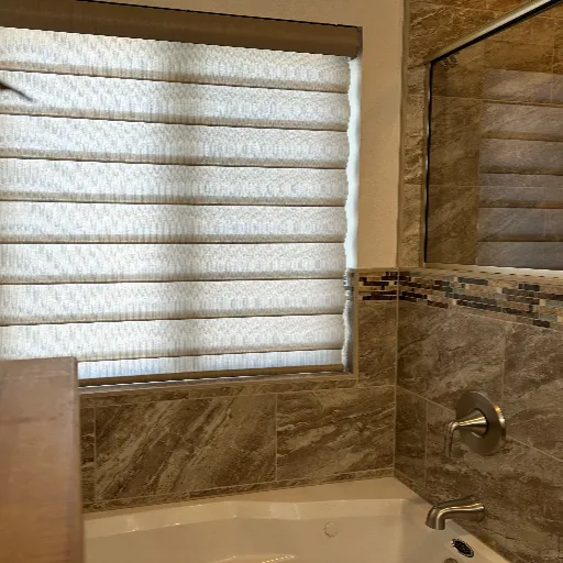 Closed bronze blinds over a bathtub 